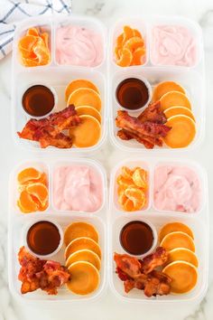 six plastic trays filled with food on top of a marble countertop next to a blue towel