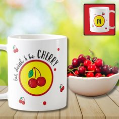 there is a bowl of cherries next to a mug with the name cherry on it