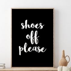 a black and white poster with the words shoes off please in cursive font