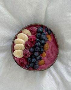 a bowl filled with blueberries, bananas and almonds