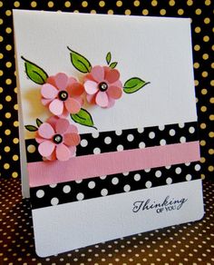 a close up of a card on a table with polka dots and flowers in it