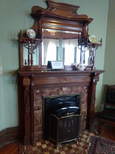 a fireplace with a mirror above it and an antique fire place in front of it