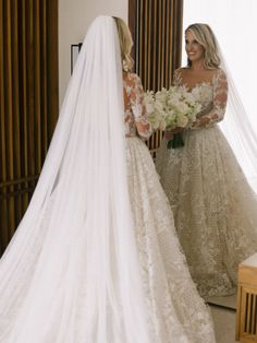 two women in wedding dresses looking at each other