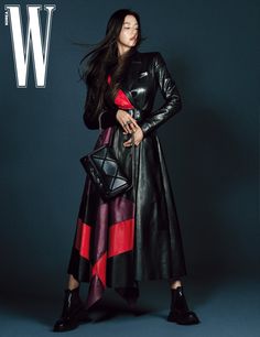 a woman in a black leather coat and red striped dress is posing for w magazine