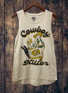 Country Deep Cowboy Killer cotton muscle tank MUSCLE CROP SIZING Sizing Model is wearing a size Small. Height is 5'6", bust 33", waist 26", and hips 36" Size S: Length measures 19” from shoulder to hem with a 19” bust Size M: Length measures 19.5” from shoulder to hem with a 19.5” bust Size L: Length measures 20” from shoulder to hem with a 20” bust 90 percent ring-spun cotton/12.5% rayon Side-seamed Relaxed, drapey fit Low cut armhole Curved bottom hem Sizes: S-XL Cowboy Killer, Muscle Tank Top, Country Concert Outfit, Country Fashion, Muscle Tank Tops, Muscle Tank, Muscle Tanks, Concert Outfit, Low Cut