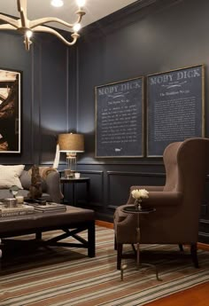 a living room with two chairs and a coffee table in front of a chalkboard on the wall