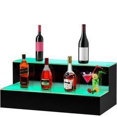 there are many different types of alcohol on this display shelf, including wine bottles and cocktails