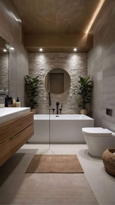 a bathroom with a large bathtub, sink and toilet next to a mirror on the wall