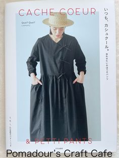 a magazine with an image of a woman in a black dress and hat on the cover