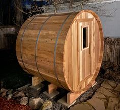 a wooden barrel sitting in the middle of a yard