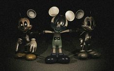 three mickey mouses are standing in the dark