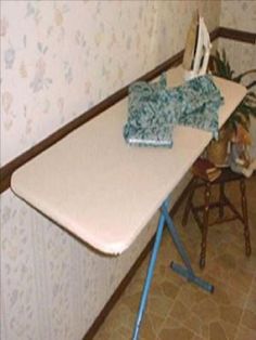 an ironing board on top of a table in a room