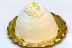 a dessert on a gold plate with white frosting