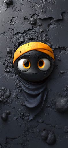 a black and yellow mask with eyes sticking out of it's head in the mud