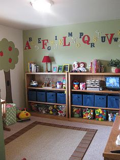 a child's playroom with toys, bookshelves and other items in it