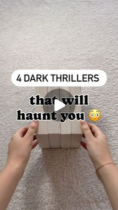 two hands holding a wooden block with the words 4 dark trailers that will haunt you