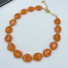 "Experience the warmth of the sun with Orange Single Strand Necklace! This vibrant piece features stunning orange beads in a single strand, adding a burst of energy and color to your style. The dainty design makes it a versatile accessory that can elevate both casual and dressy looks. Whether you're embracing the spirit of summer or brightening up your winter ensemble, this necklace is a symbol of joy and positivity. Embrace the allure of orange and let your style shine with this exquisite piece Orange Statement Necklace, Salmon Orange, Necklace Orange, Autumn Necklace, Orange Necklace, Christmas Necklace, Necklace Beaded, Handcrafted Necklace, Halloween Jewelry