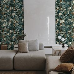 a living room with floral wallpaper and couches