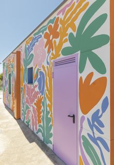 a colorful building with flowers painted on it