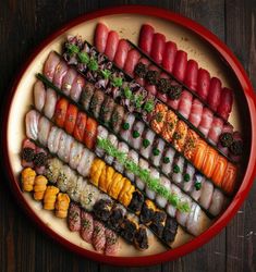 an overhead view of sushi on a plate with chopsticks in the middle