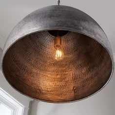 a large metal light fixture hanging from a ceiling