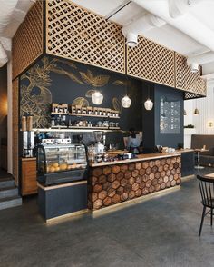 the interior of a coffee shop with wood paneling