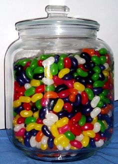 a glass jar filled with lots of colorful candy