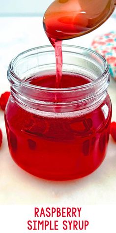 raspberry simple syrup is poured into a jar