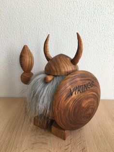 a wooden statue with a viking's hat on it