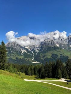 the mountains are covered in snow and clouds