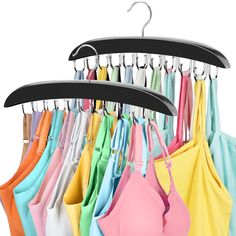 an assortment of bras hanging on a rack in front of a white background,