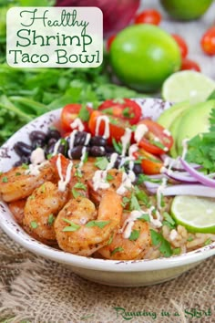 healthy shrimp taco bowl with cilantro, black beans, tomatoes and avocado