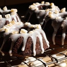 chocolate bundt cake with white icing on a cooling rack