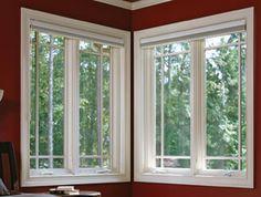 two windows in a room with red walls