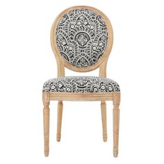 a wooden chair with a black and white patterned seat pad on the back of it