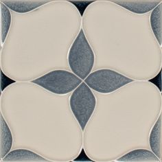 a white and grey tile with an intricate design