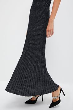 We are living for the Black Metallic Jesse Skirt. Made in an ankle-skimming length that gives it an elevated elegance, this shimmering silhouette is ultra-flattering thanks to a high rise and ribbed knit texture with plenty of stretch. It's semi-sheer for a sultry feel — so it's suited for date nights and sparkling soirees alike! Just pair this maxi with a crisp white blouse and ballet flats, with a soft sweater and heeled booties, or with a silky blouse and pumps for a showstopping look. High r Crisp White Blouse, Knit Texture, Silky Blouse, Sheer Material, Soft Sweater, Kids Sale, Date Nights, Softest Sweater, Black Metallic