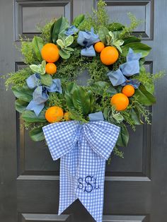 an orange and blue gingham wreath on the front door