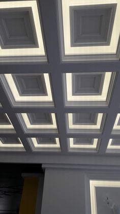 the ceiling in this room has many square lights on it