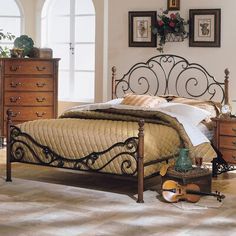 a bedroom scene with focus on the bed and dresser