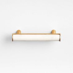 an image of a white and gold door handle on a white wall with no one in it