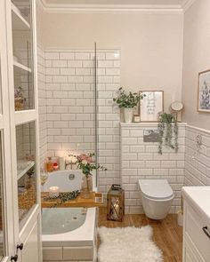 a bathroom with a tub, toilet and sink in it's own area is shown