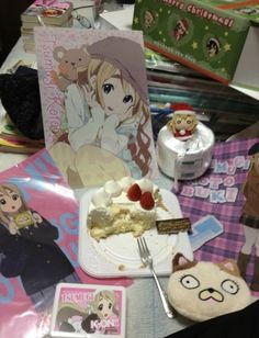 a table topped with lots of food and anime themed items on top of each other