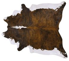 a cowhide rug with brown and white spots on the top, in front of a white background