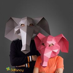 two people with paper masks on their faces and one wearing an elephant's head