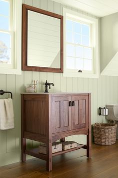 a bathroom with a sink, mirror and towel rack on the wall next to it