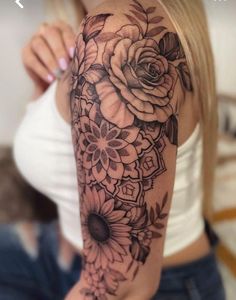 a woman with a flower tattoo on her arm