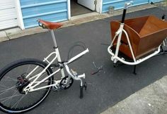 a white bicycle with a wooden basket attached to it