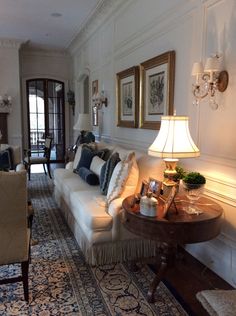 a living room filled with furniture and a lamp