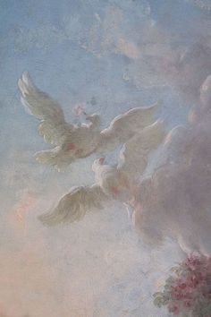 two white doves flying in the sky with pink and blue flowers on it's side